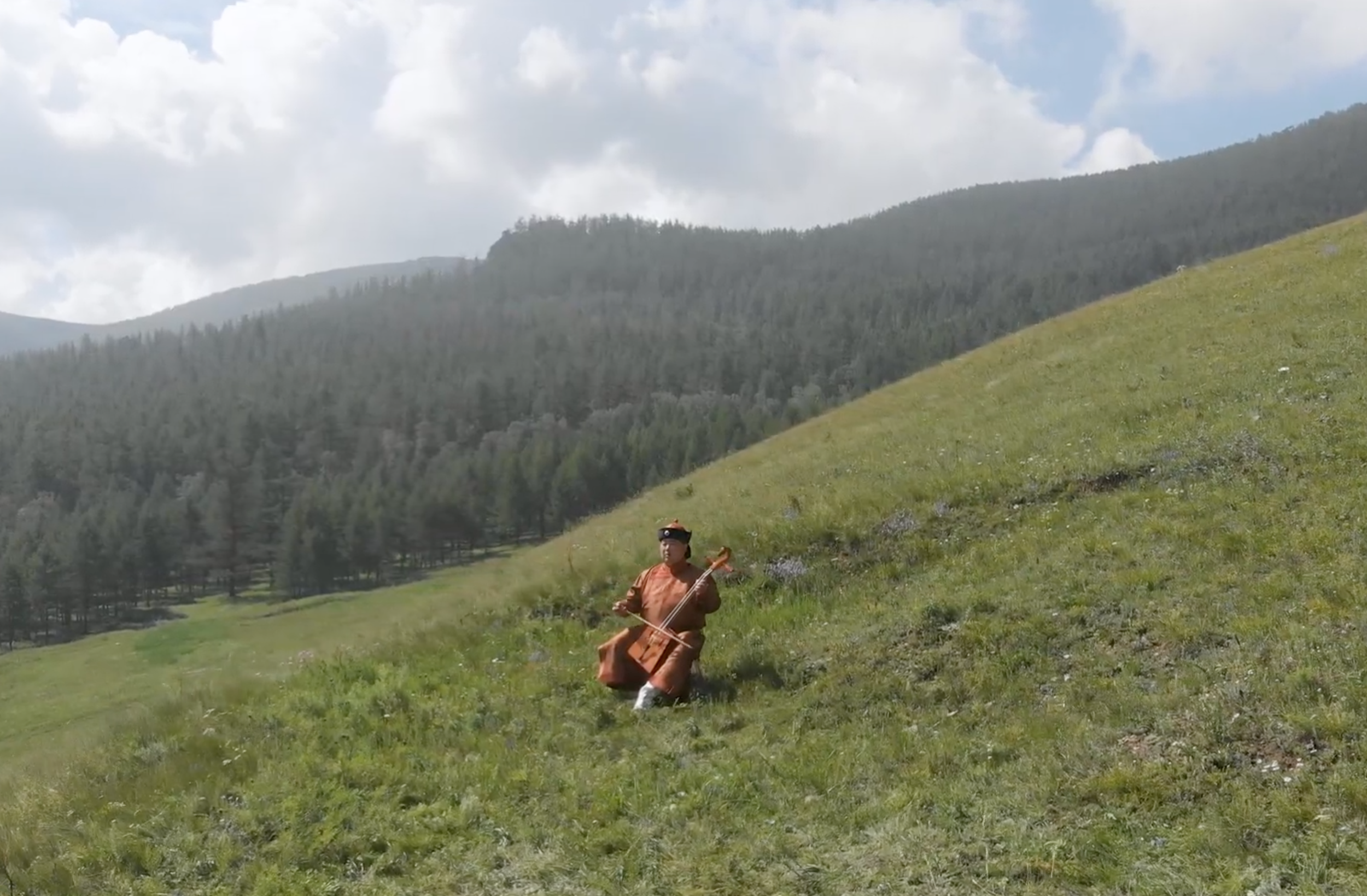 Human figure walking through mountain landscape captured for documentary storytelling