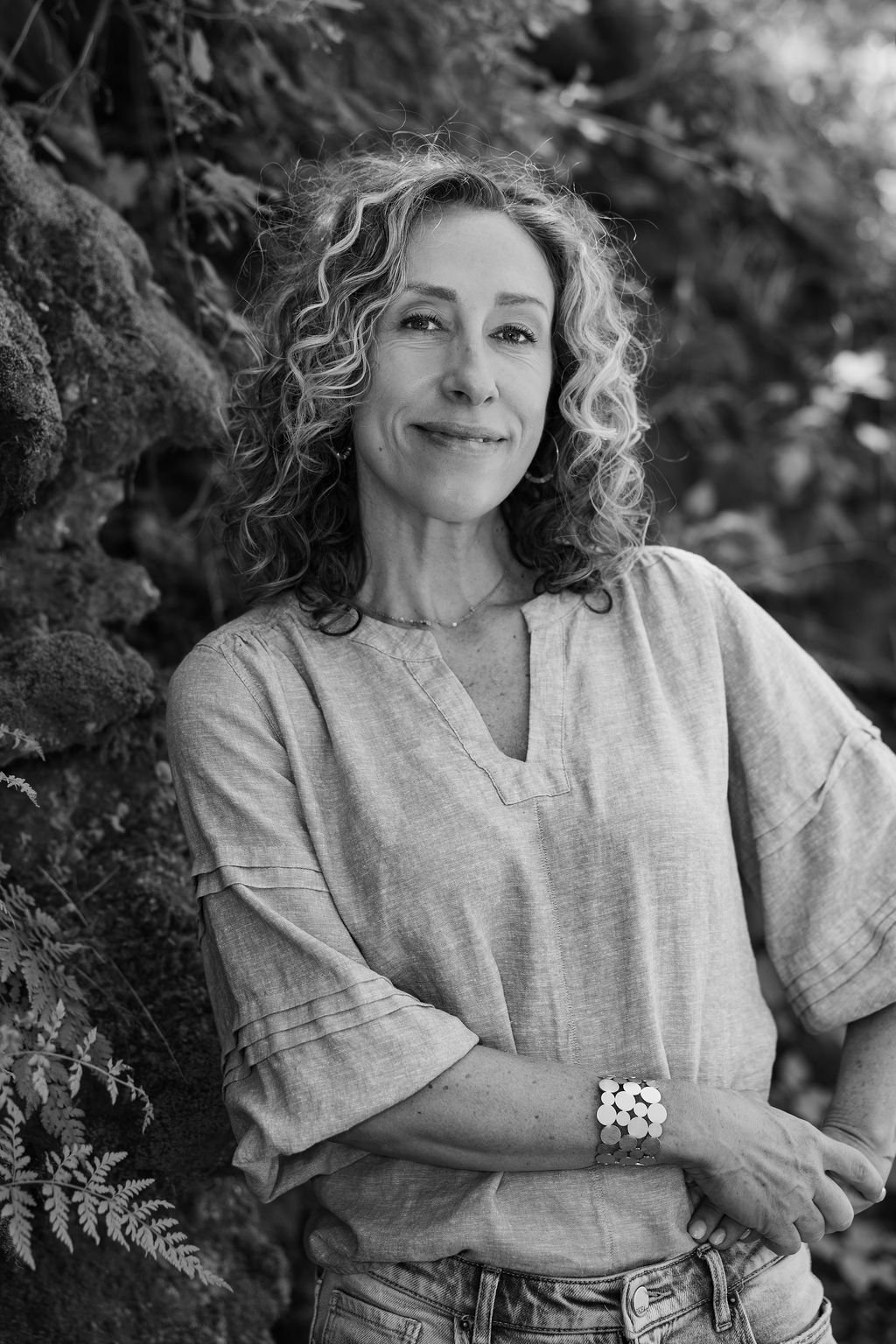 black and white headshot of a smiling therapist with a nature background