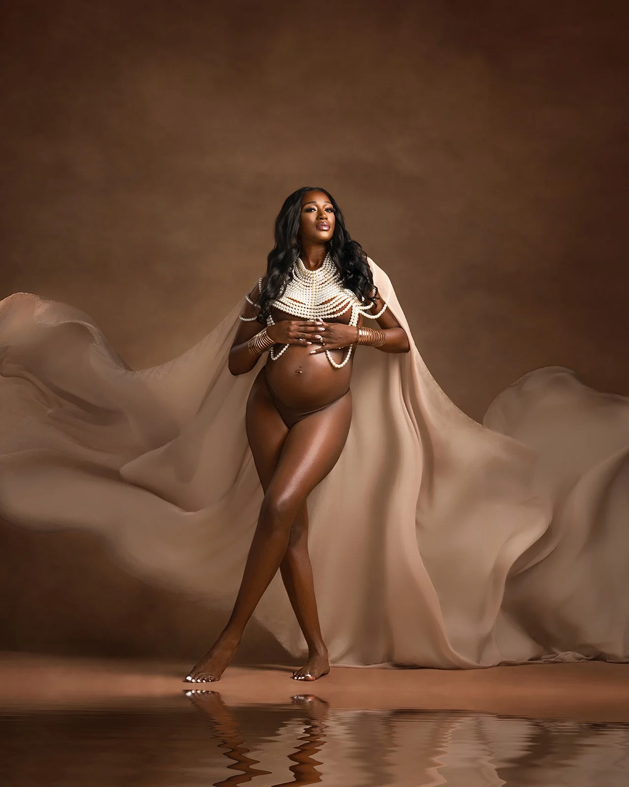 Luxury maternity portrait photographed in a professional studio setting