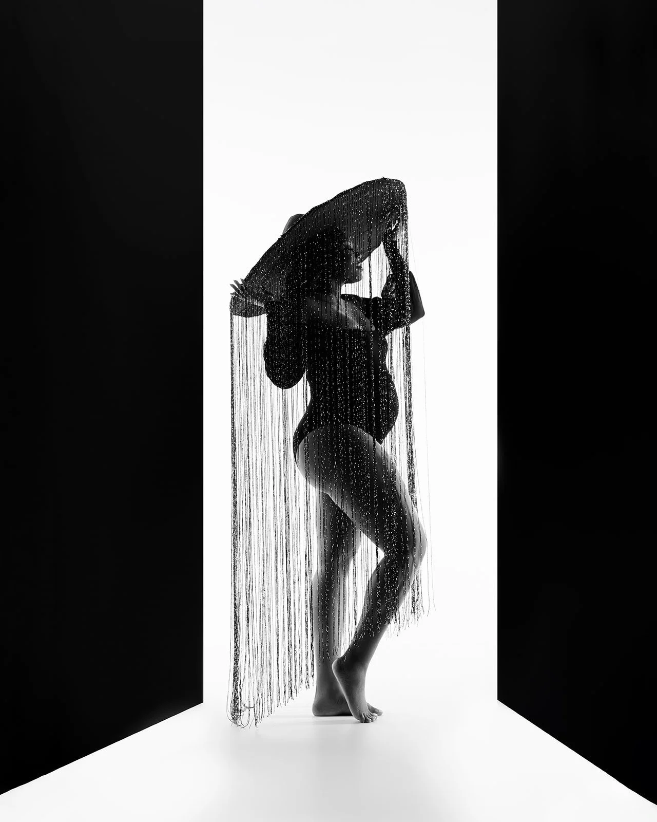 Elegant pregnancy portrait photographed with sculpted studio lighting