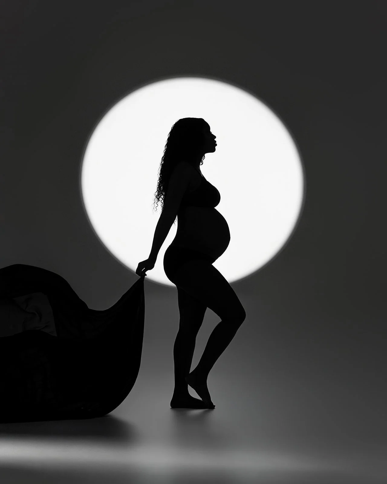 Studio maternity portrait highlighting pregnancy silhouette photographed in Cypress Texas