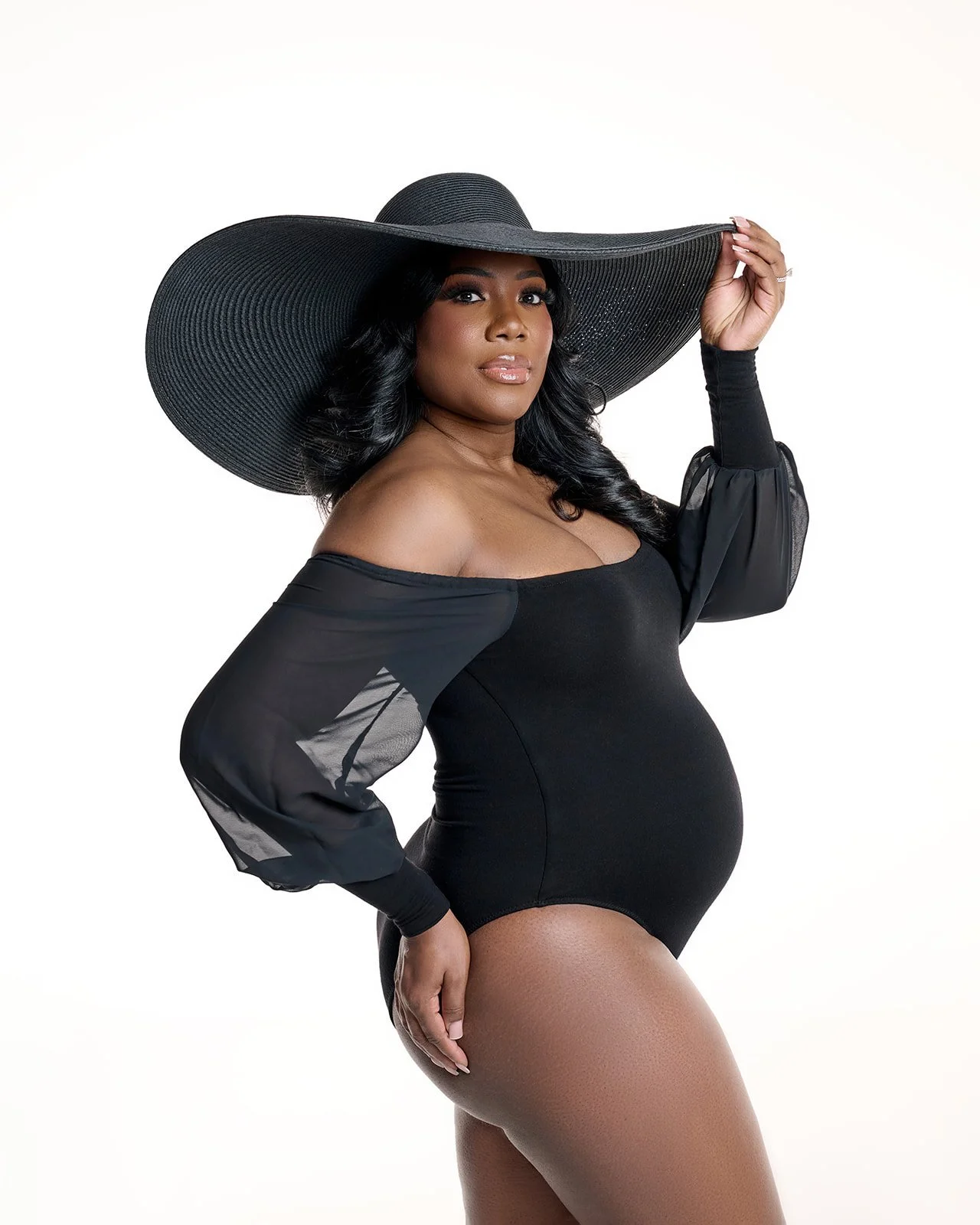 Dramatic lighting maternity portrait created in Houston area photography studio