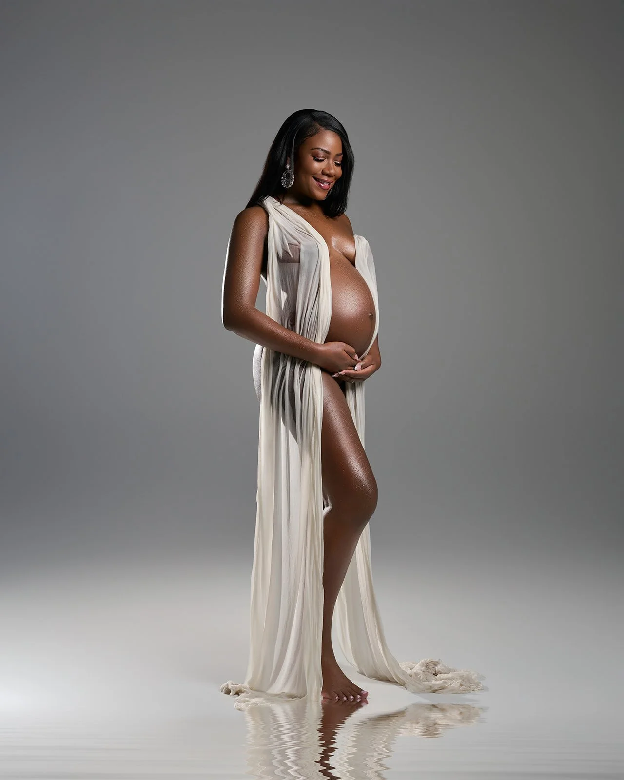Elegant maternity portrait photographed with professional studio lighting