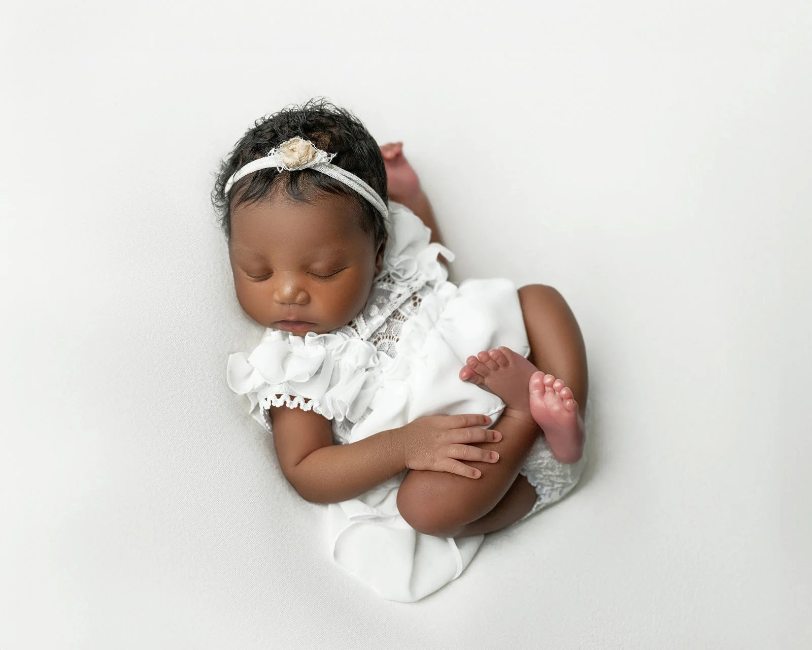 Elegant newborn photography session in a professional studio serving Houston and Cypress Texas families