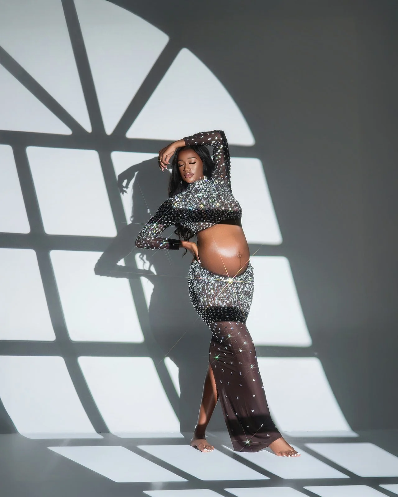 Fine art pregnancy photography session highlighting motherhood in Houston area studio