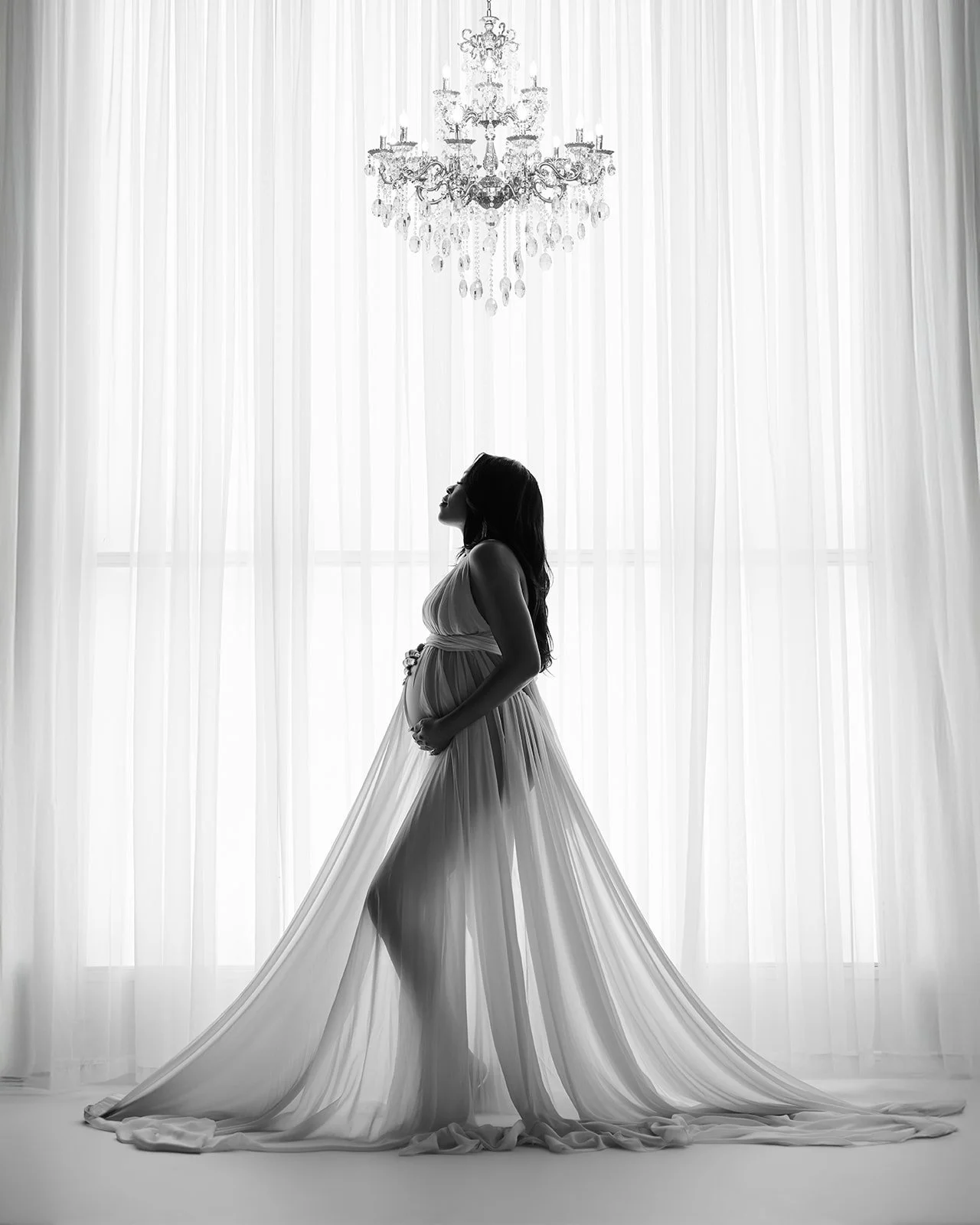 Pregnancy photoshoot with dramatic studio lighting photographed near Houston Texas