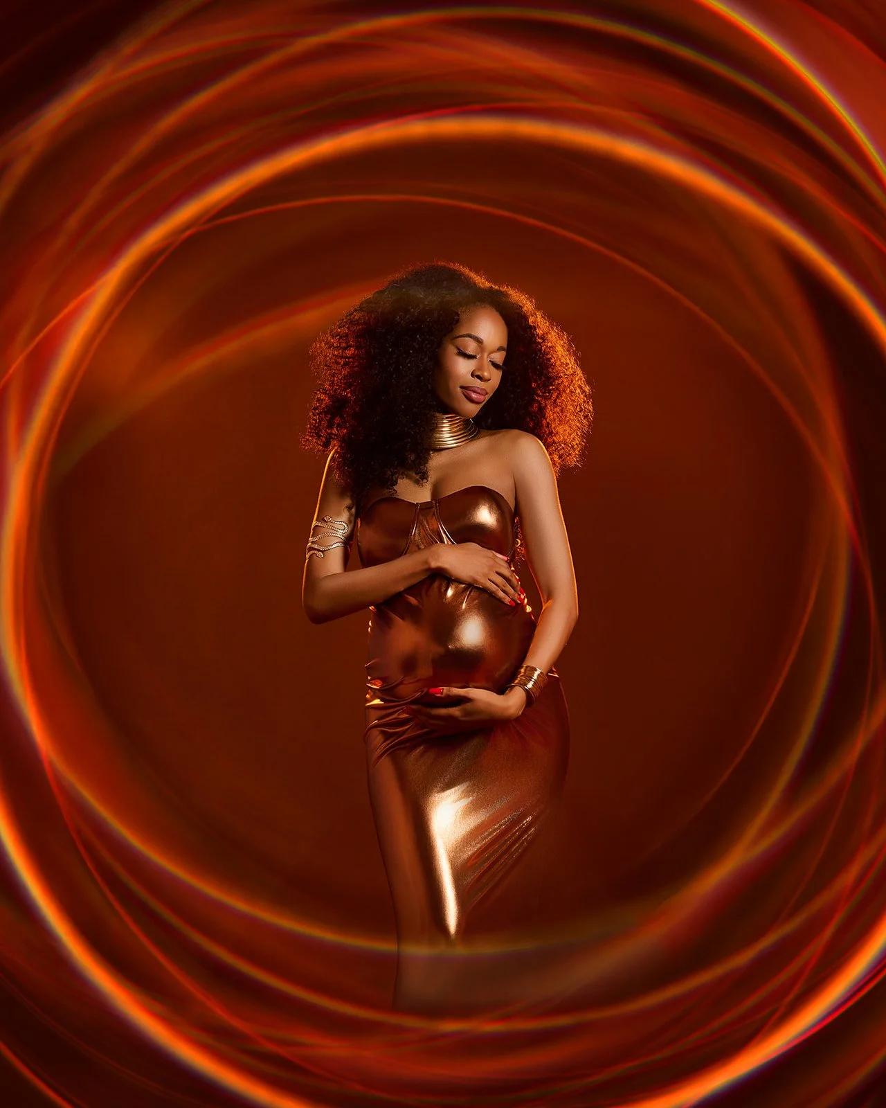Pregnant woman in a metallic gold dress surrounded by circular warm light effects in a creative Houston maternity portrait.
