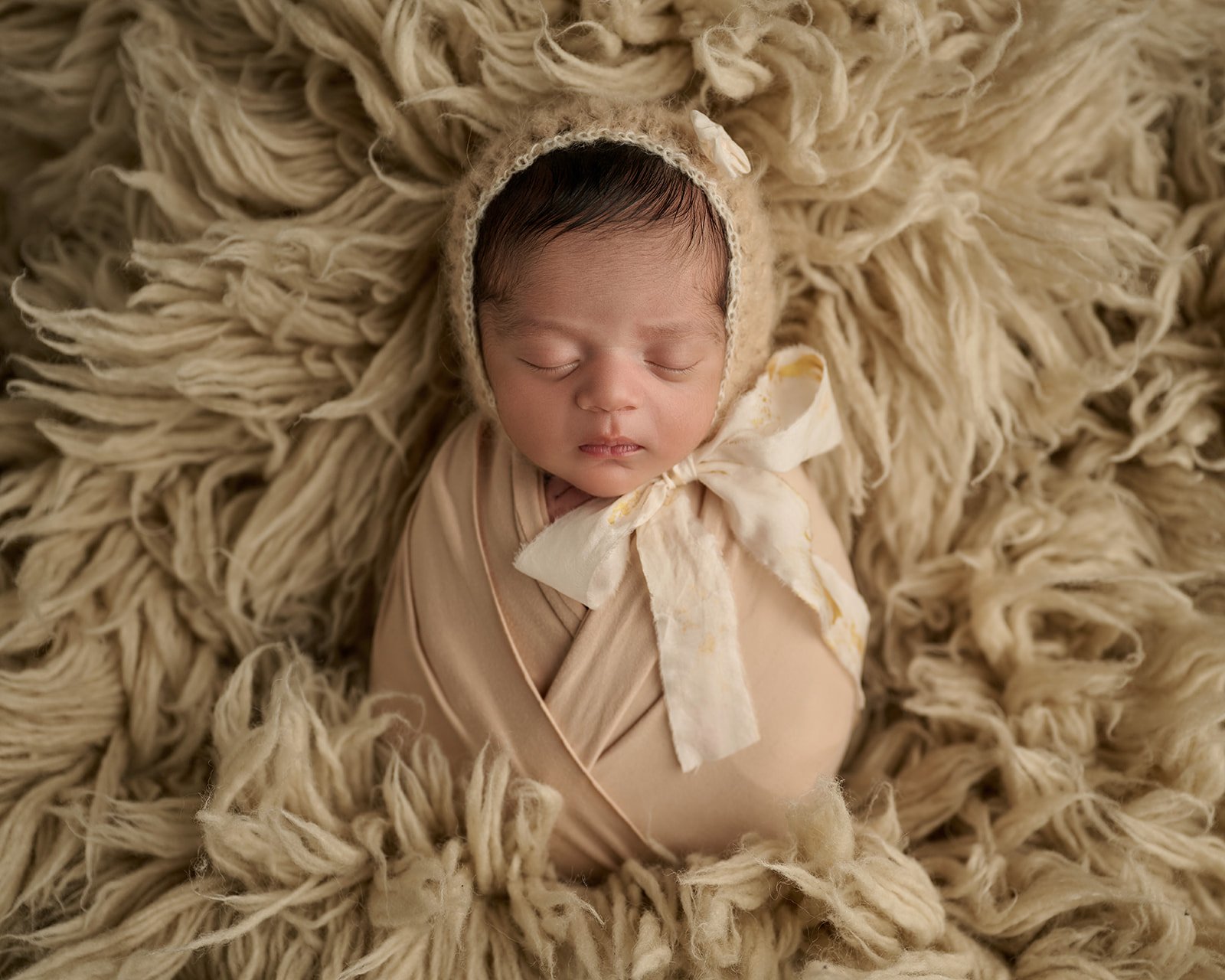 Elegant newborn baby portrait photographed with soft lighting in Houston area photography studio