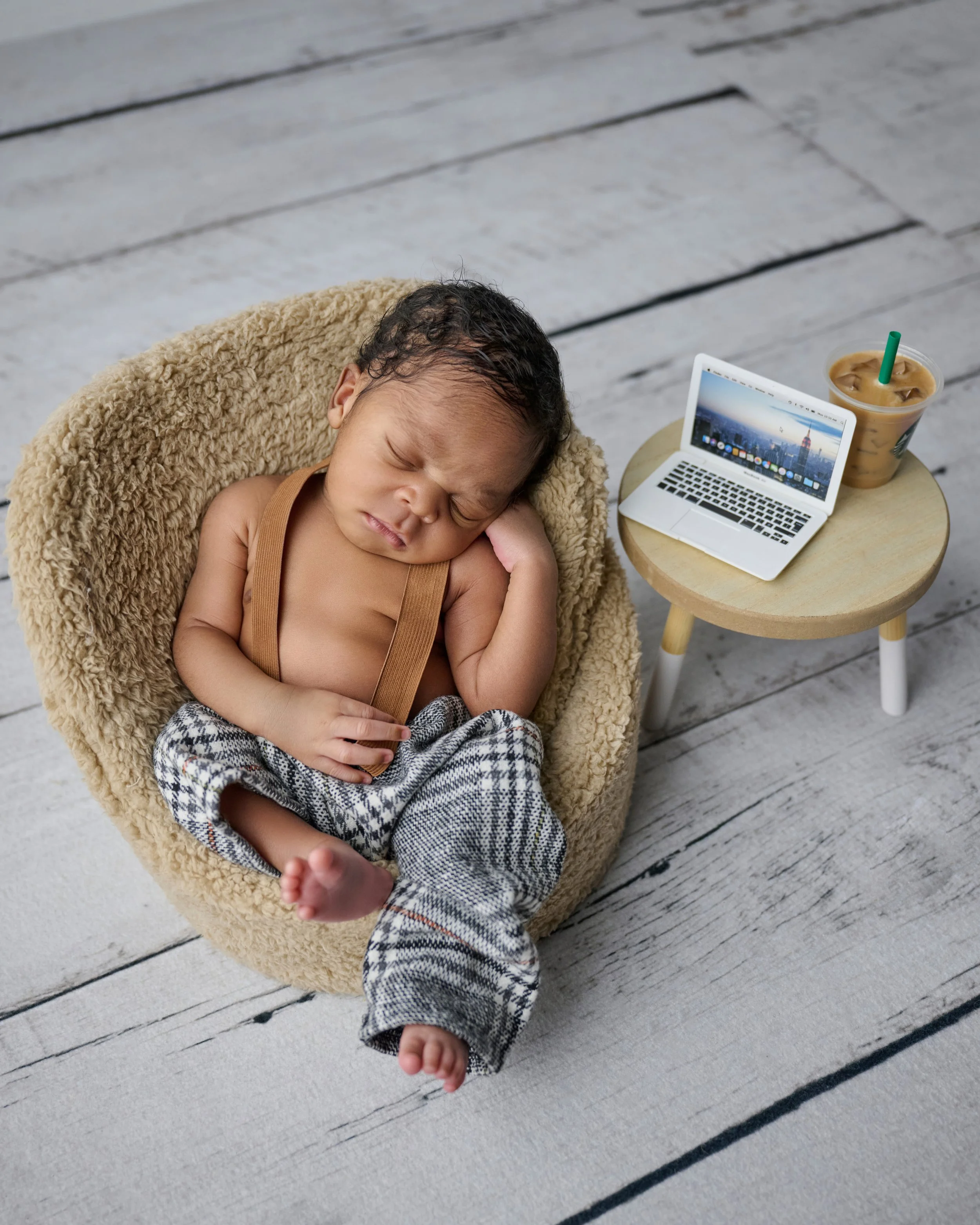 Professional newborn photography session capturing a sleeping baby in Houston studio