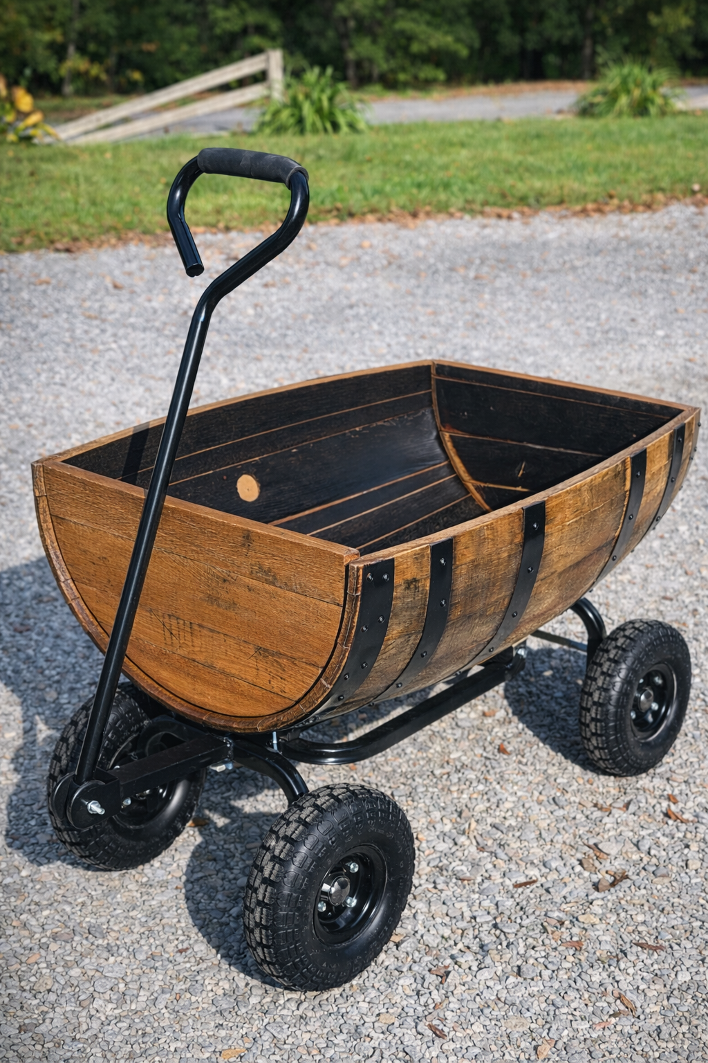 Handmade rustic wooden wagon cart with metal frame and all-terrain wheels, crafted from reclaimed wood. A durable decorative and functional piece ideal for yard décor, landscaping, or rustic outdoor spaces.