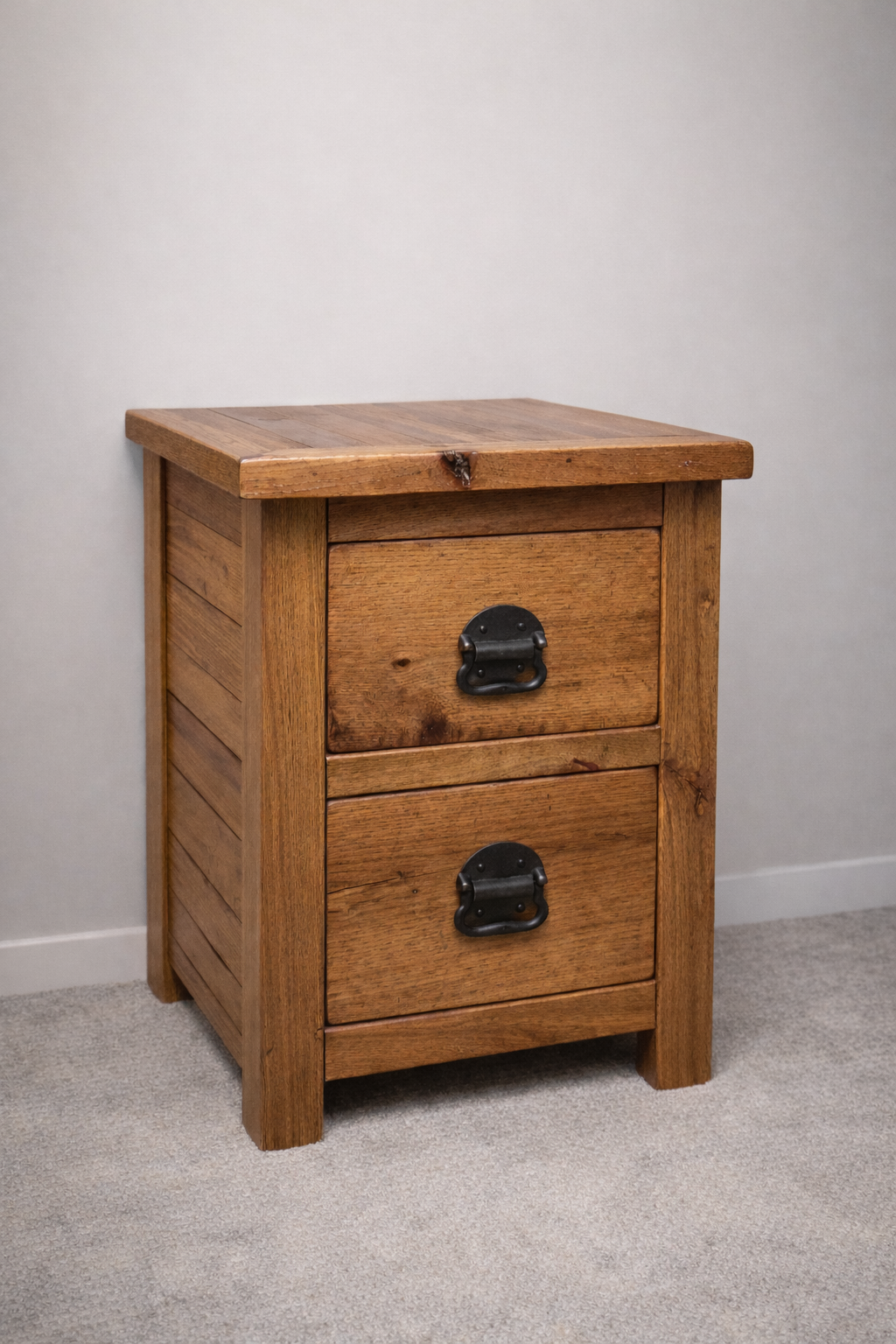 Handcrafted solid wood nightstand with two drawers and rustic metal hardware. A durable farmhouse-style bedside table built from premium hardwood.