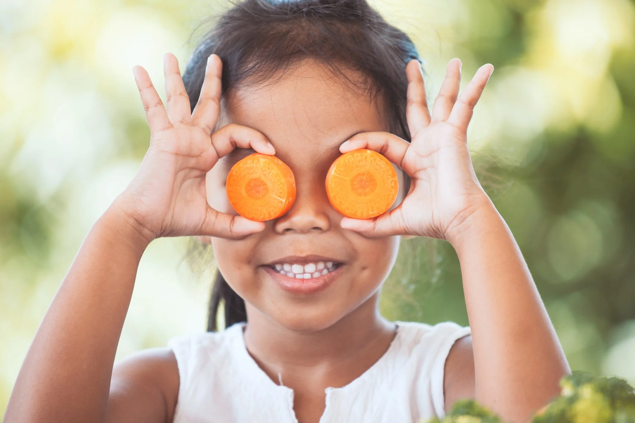 A girl playing with food as part of feeding therapy