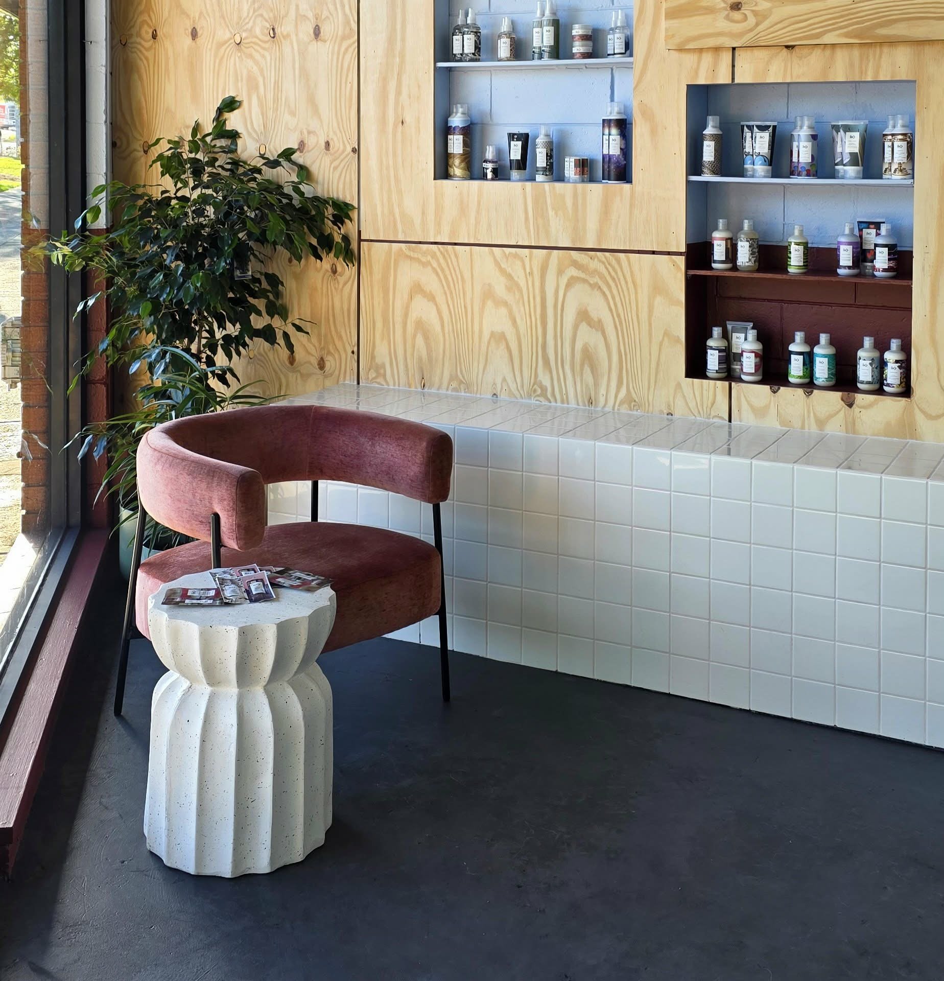 Bright modern salon interior at Foam Salon Somerville with styling stations and plants