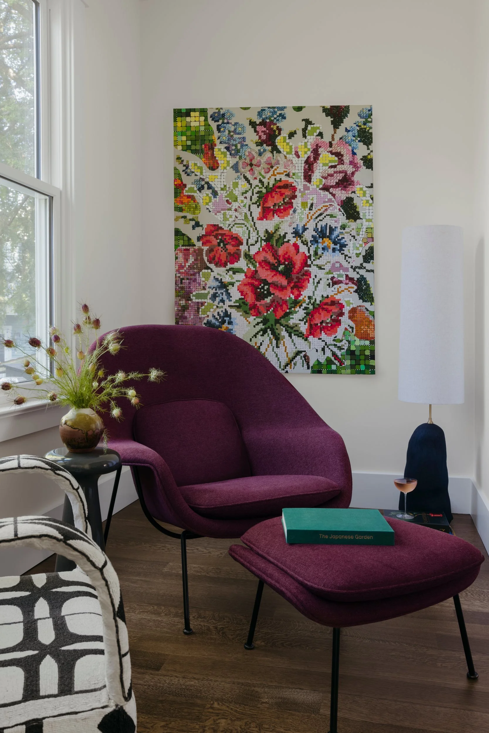 Burgundy Womb chair in the reading room with original artwork by Kirsten Lamb