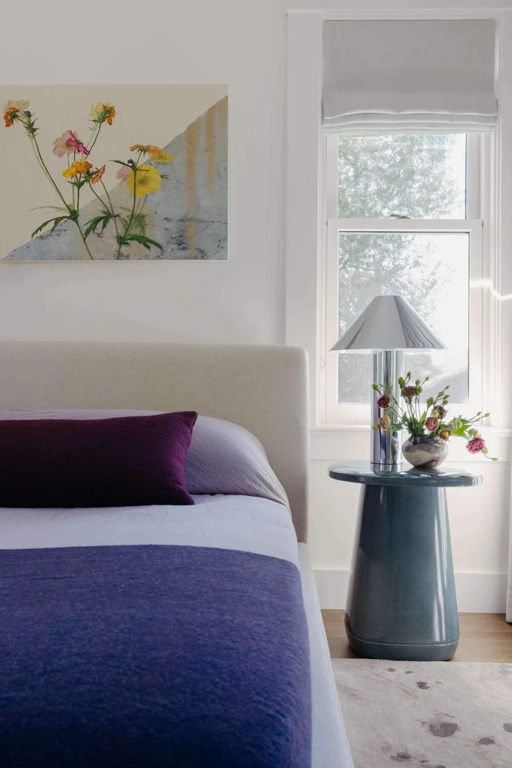 Bedside detail with a modern side table and lamp, custom artwork by Will Brown and a Michelle Dirkse Collection rug