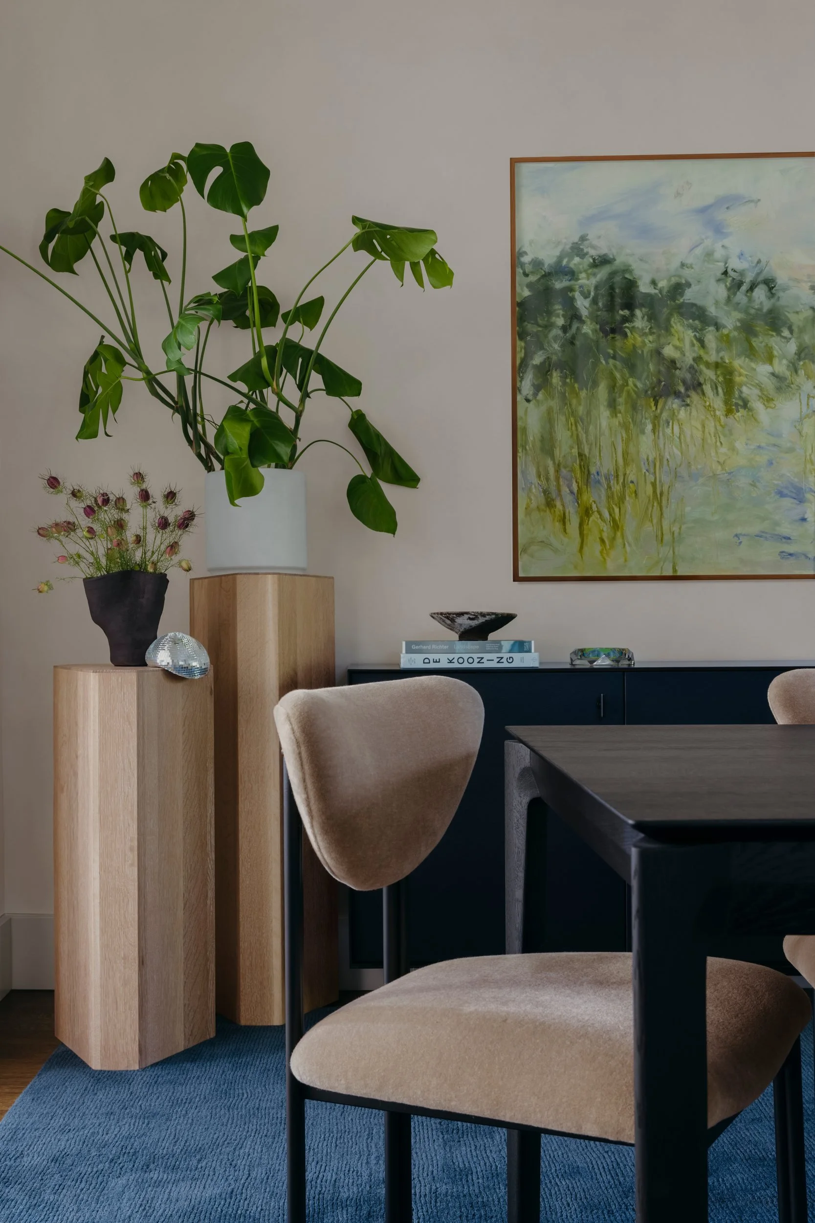 Beige mohair dining chairs, light wood pedestals and a soft floral abstract painting by Mya Kerner