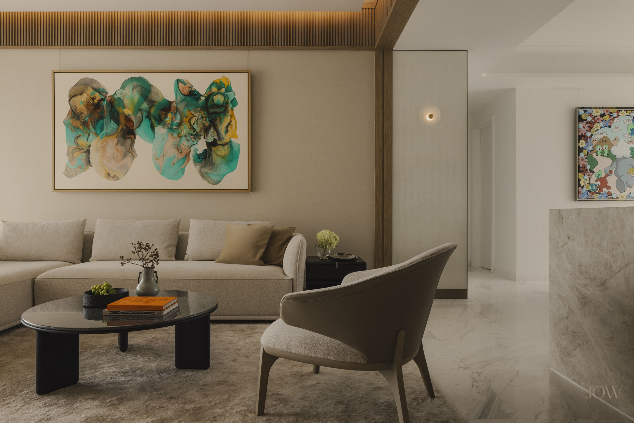 Modern living room interior design featuring sofa, a sculptural armchair, and black coffee table layered with books, complemented by abstract artwork by Fintan Whelan.