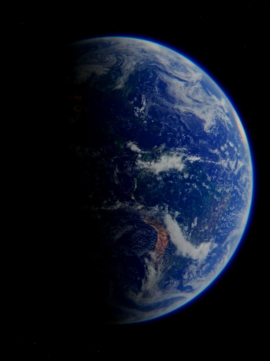 View of Earth from space showing continents, clouds, and the planet's curvature, with space in the background.