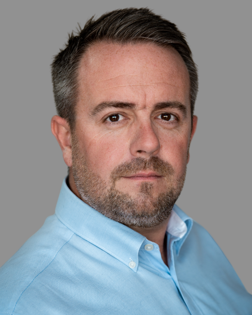 Construction company team member with short hair wearing a pale blue shirt