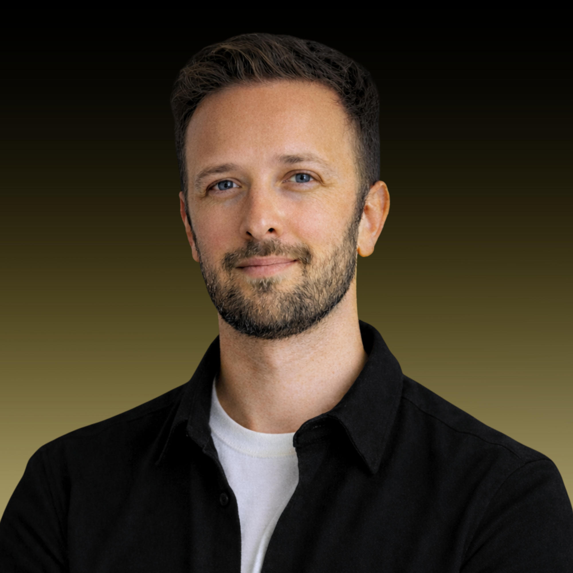 Portrait of a man with short brown hair and a beard, wearing a black shirt and a white t-shirt, smiling slightly against a dark gradient background.