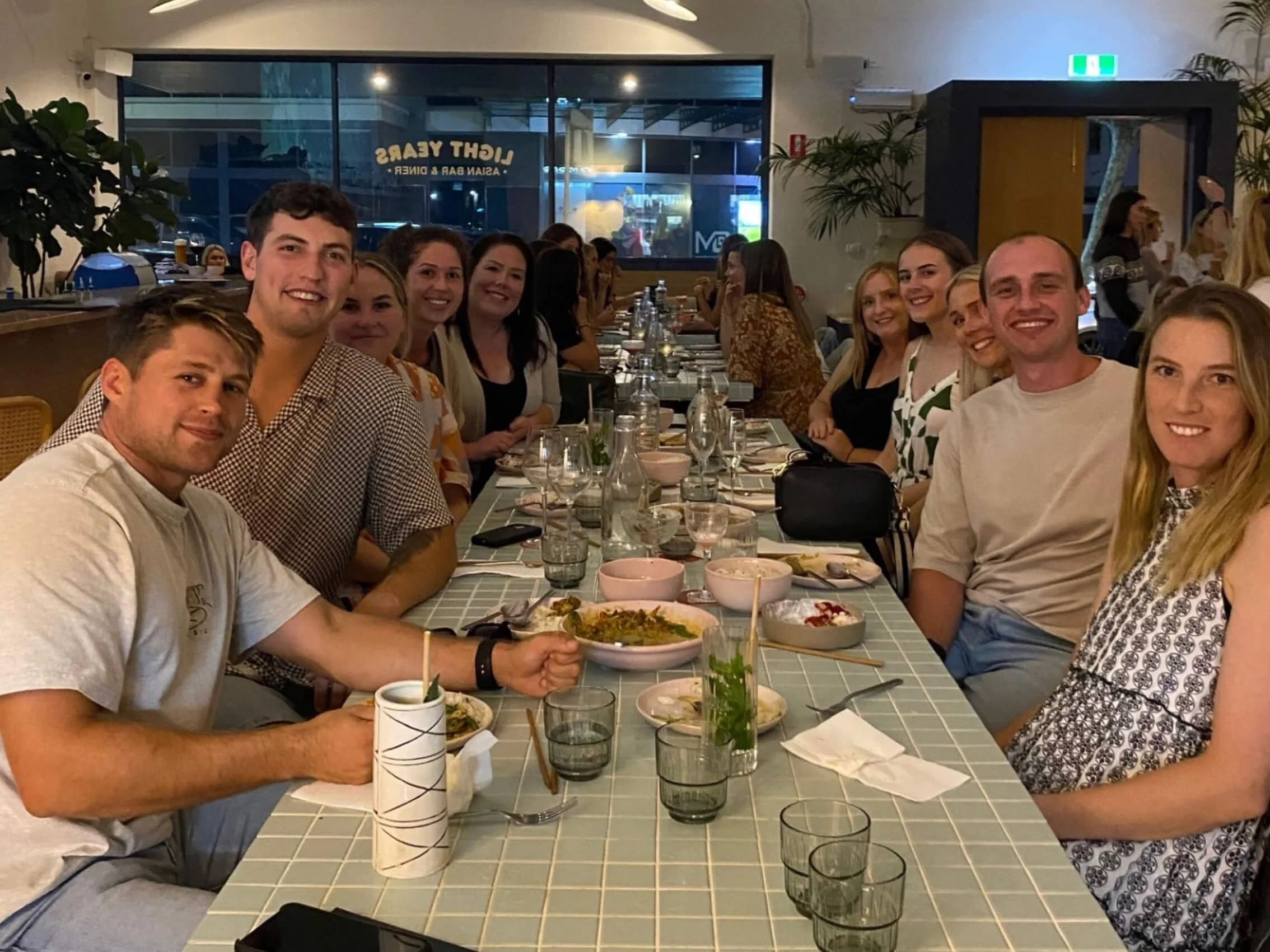 a group of smiling therapist at dinner table enjoying themselves