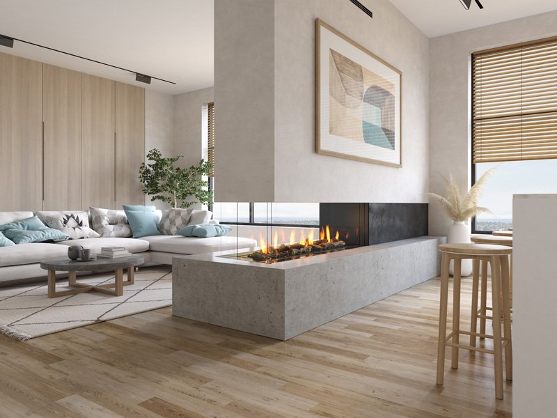 Modern living room with a white sectional sofa, light wood coffee table, abstract wall art, fireplace, large window with blinds, and decorative plant.