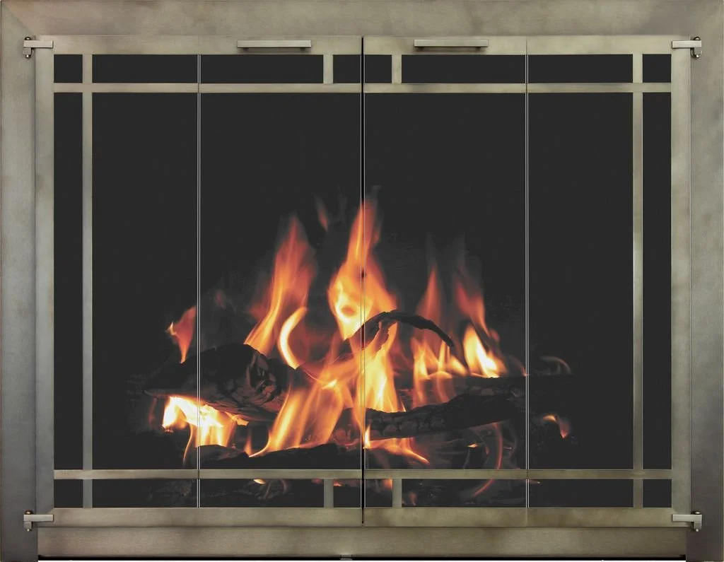 Fire burning inside a metal fireplace with sliding doors.