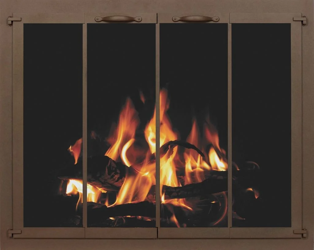 Fire burning behind glass panels framed in beige with metal handles.