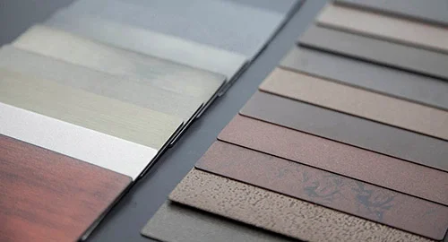 Samples of different colored and textured wood or laminate flooring options displayed in an open catalog.