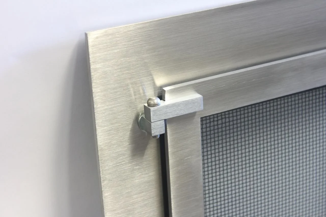 Close-up of a stainless steel screen frame with a corner bracket and a small metallic ball on top of the bracket.