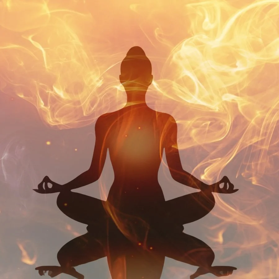 silhouette of female sitting in yoga pose with hands in mudra surrounded by flames of shakti fire rising