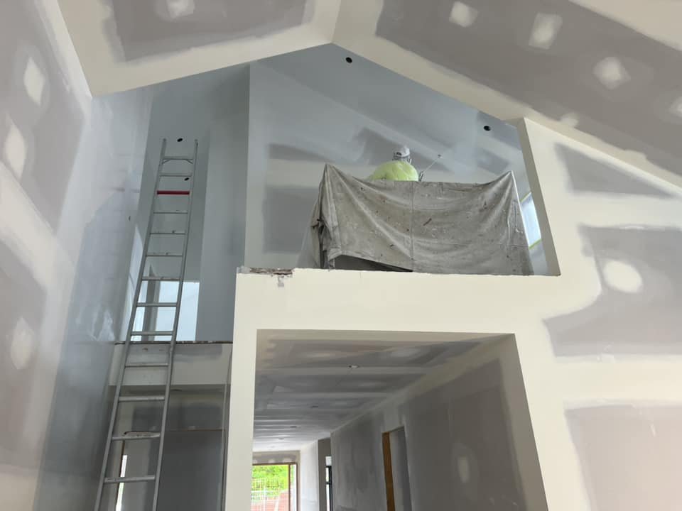 Oranssi technician working on a roof project