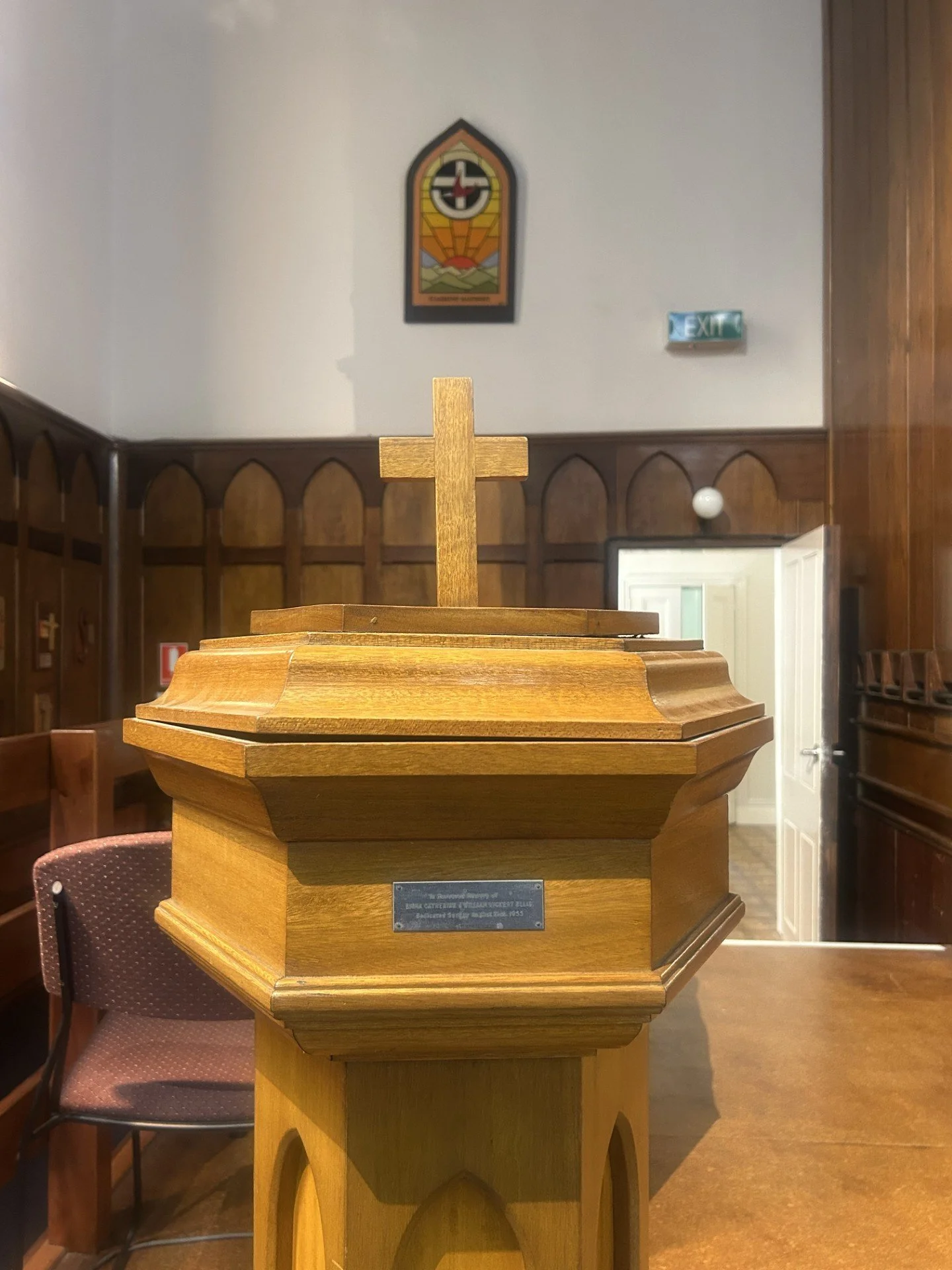 A wooden cross on a raised platform inside a church.