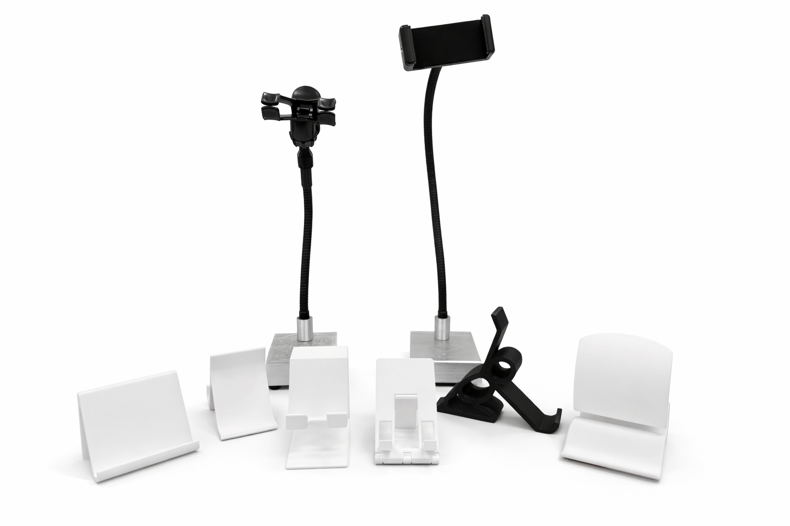 A variety of mobile device holders and stands, including two flexible gooseneck mounts with clamps and smartphone holders, and several white and black stands of different shapes and sizes.