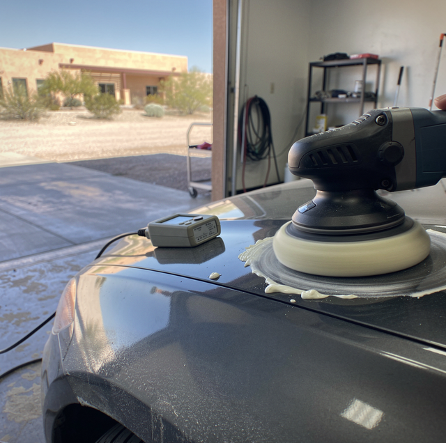 microfiber cloth revealing swirl marks on glossy car paint