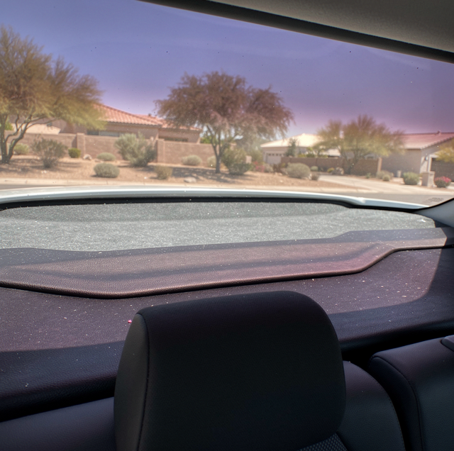 Faded purple window tint on car rear windshield at low sun