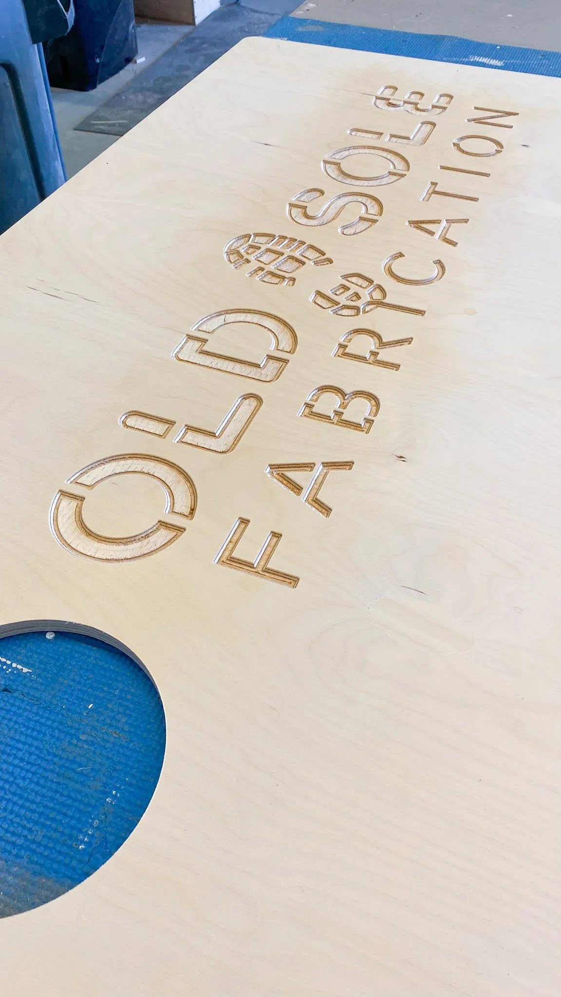 Wooden surface with laser-engraved text.