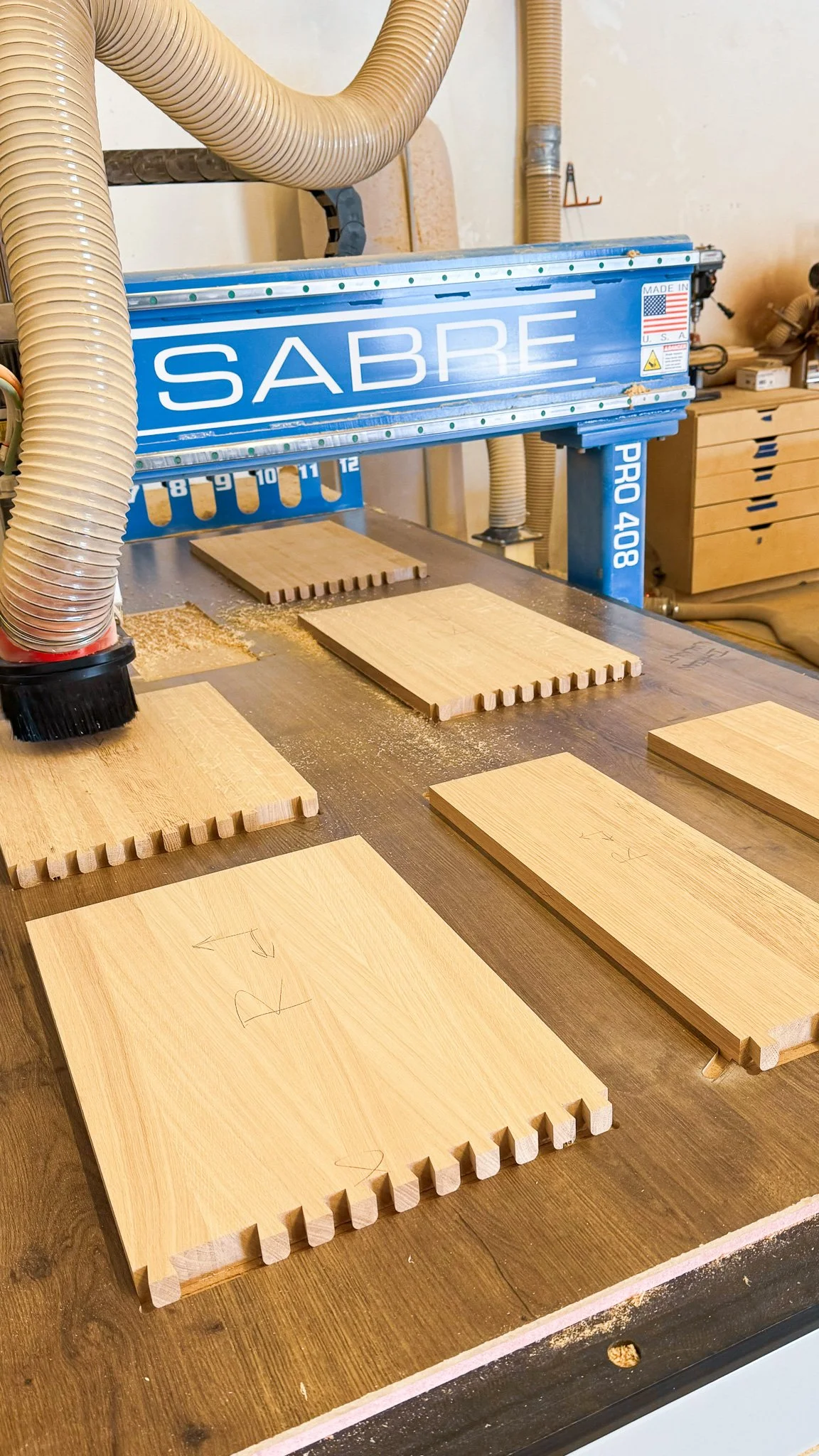 Woodworking shop with wooden boards and shop sabre cnc router.