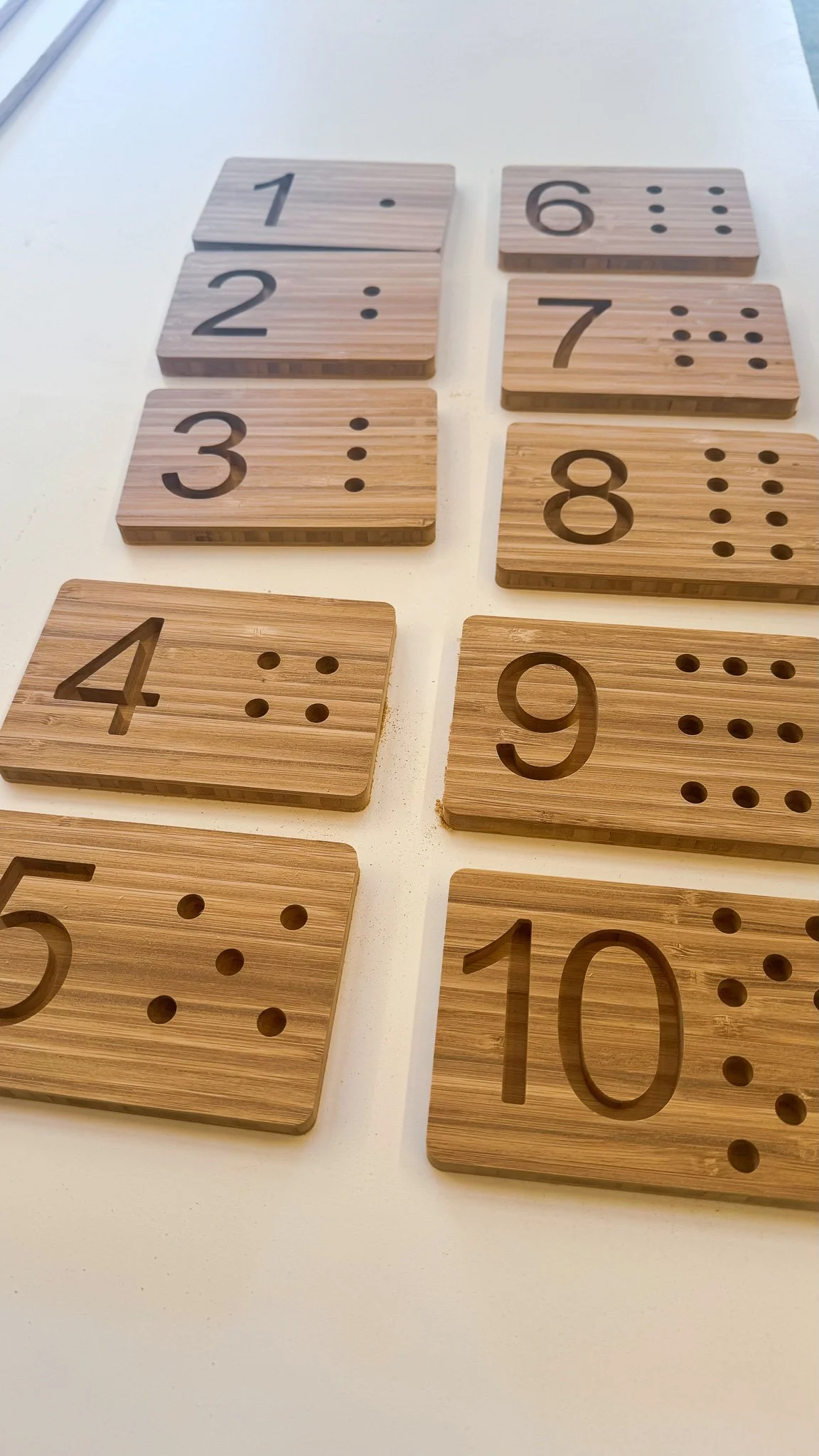 Wooden number blocks with numbers 1 to 10 and matching dot patterns for counting.