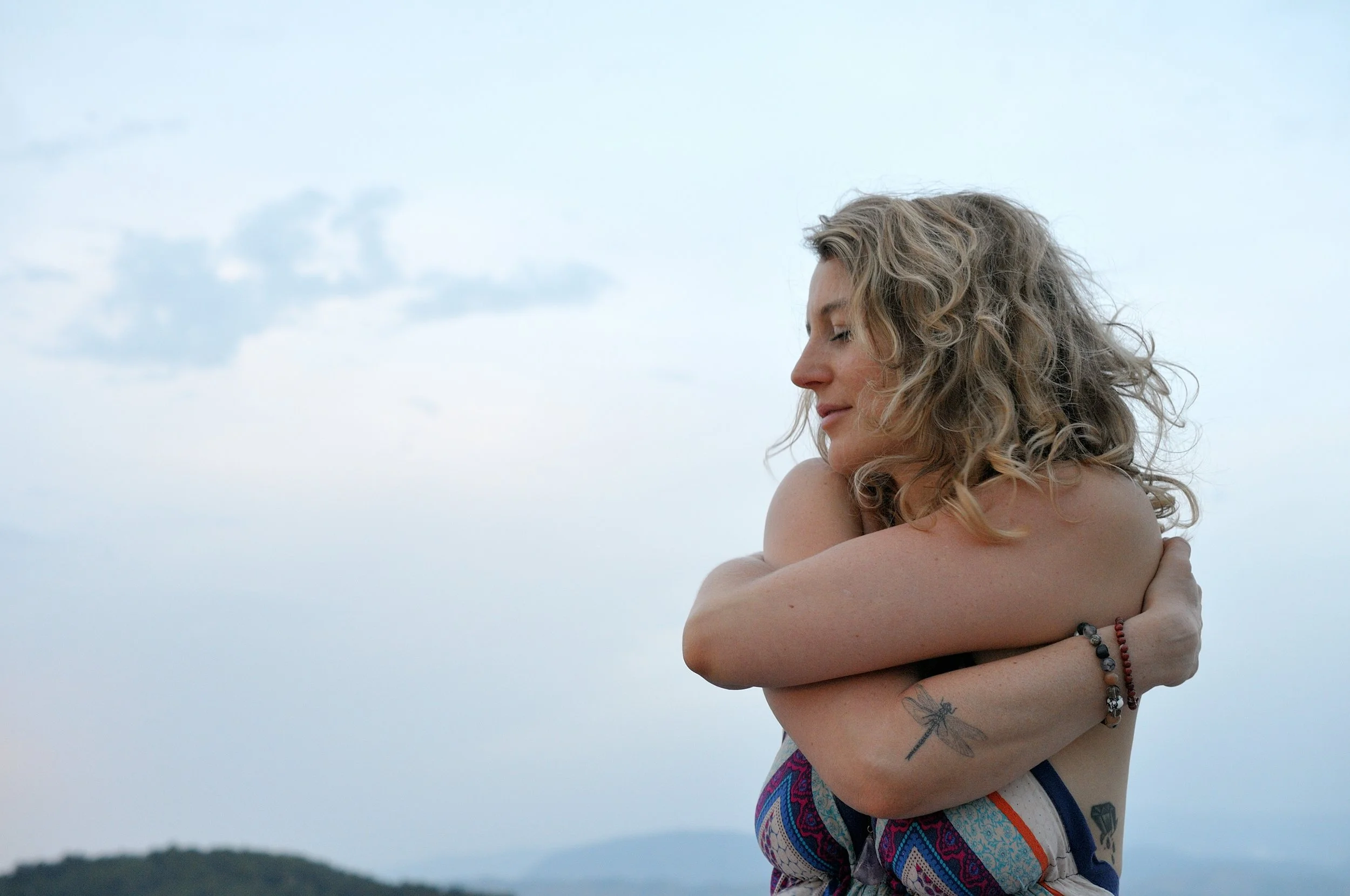 Sunny hugging herself lovingly.