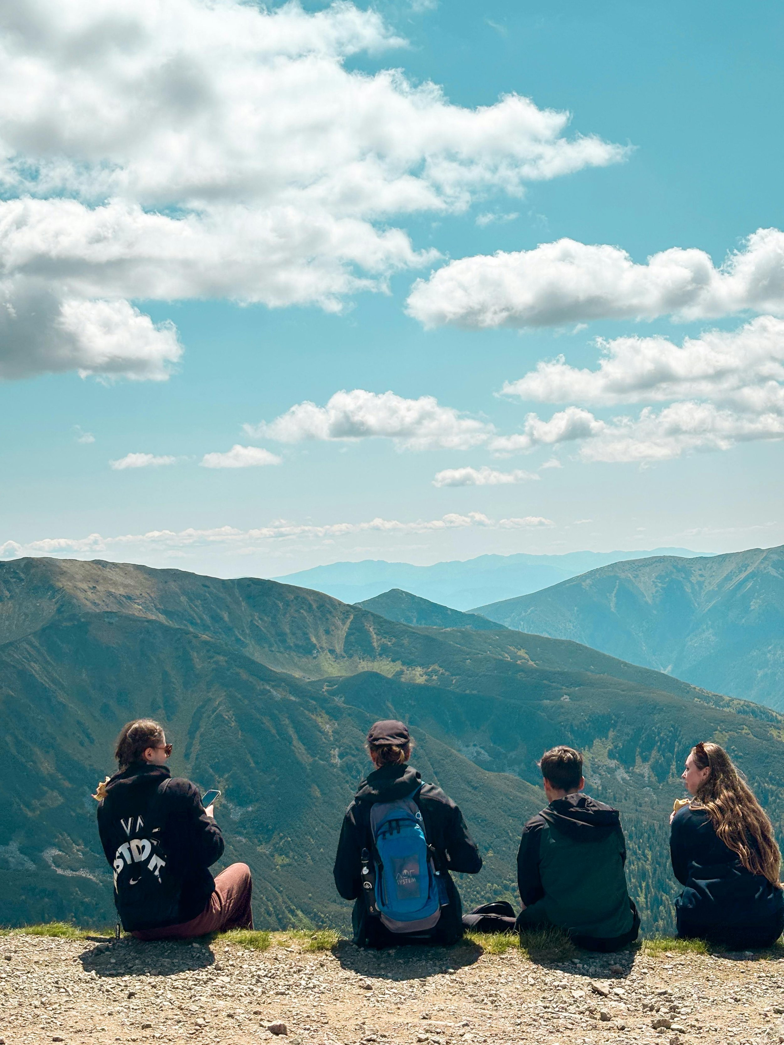 Young people on cliff edge in nature on hike