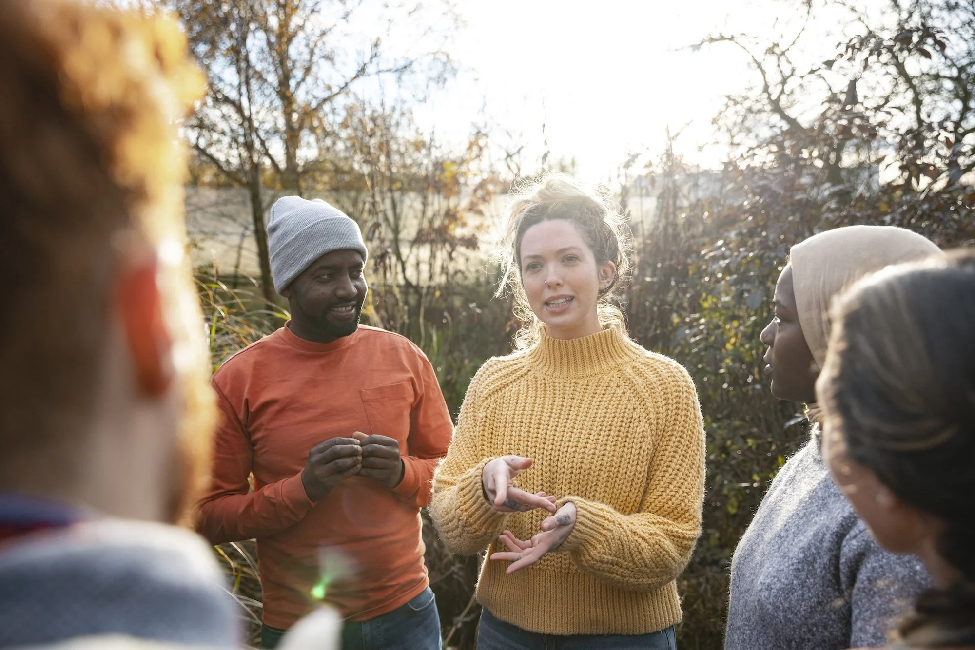 A group stand in nature and have a discussion about climate