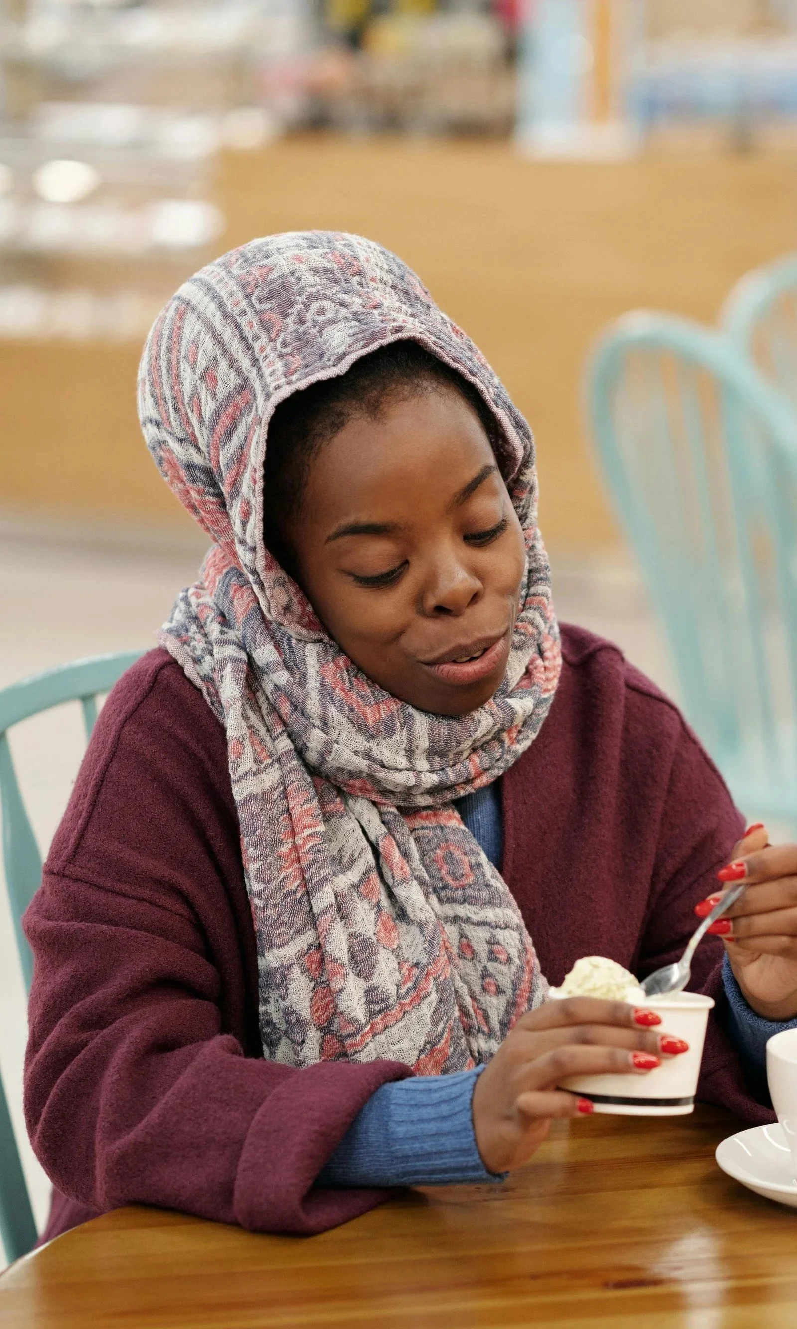 Woman in headscarf thinking in conversation