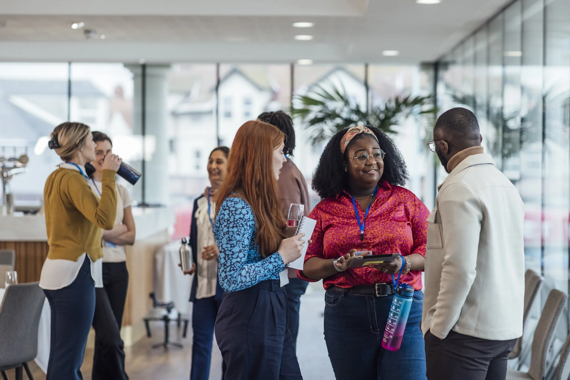 Employees in office gather round to discuss climate change.