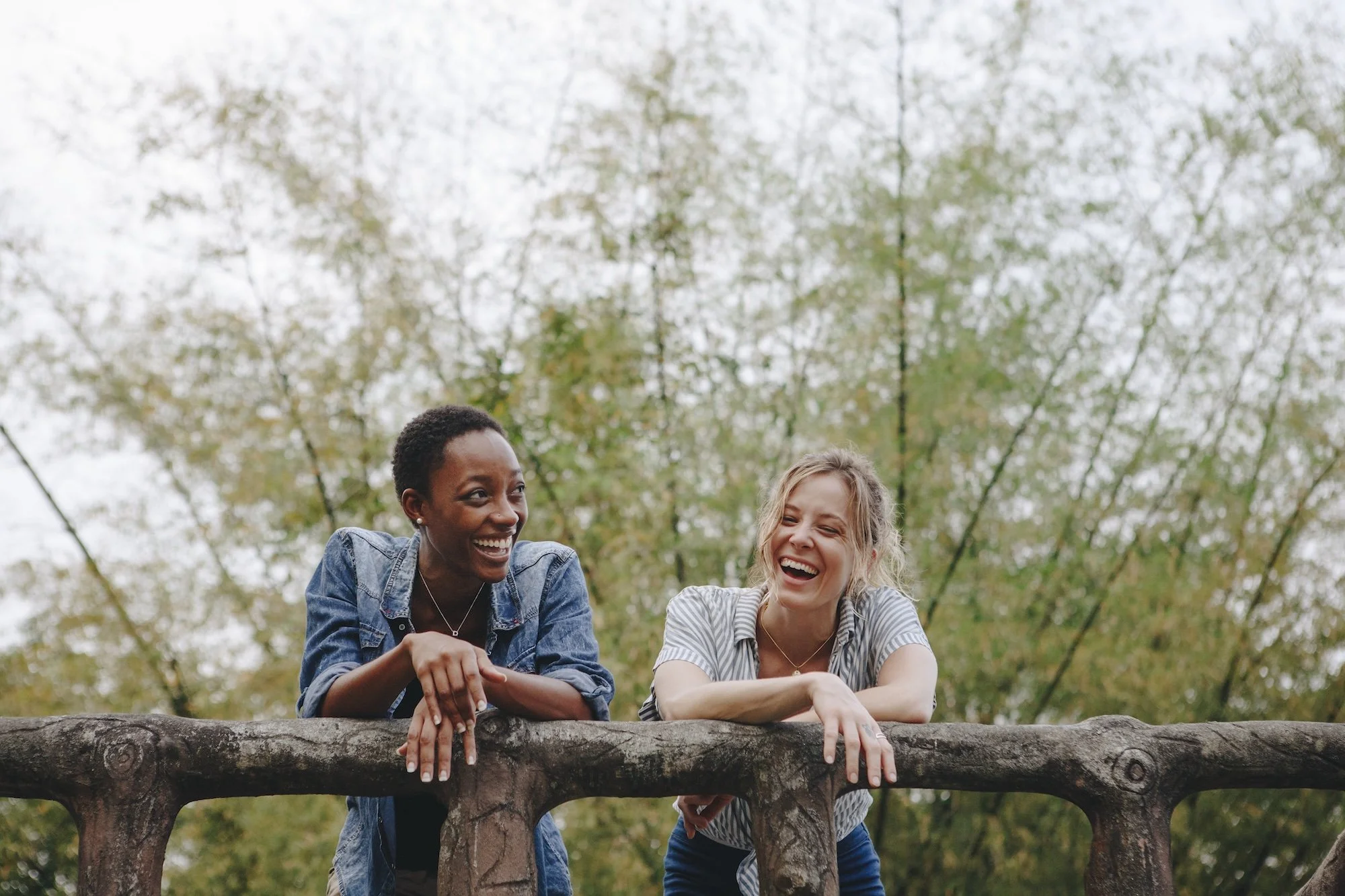Two women having a lighthearted conversation in nature