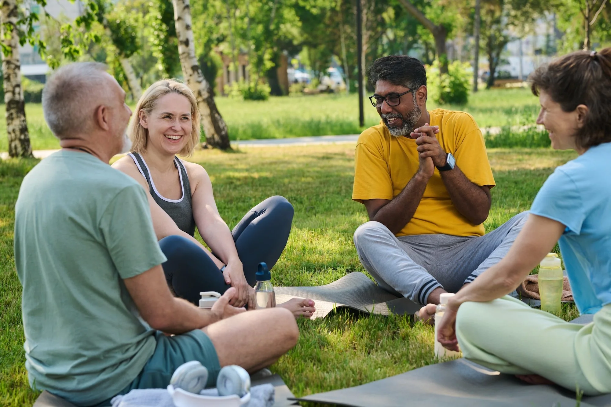 A group sitting on grass in the park discussing climate change