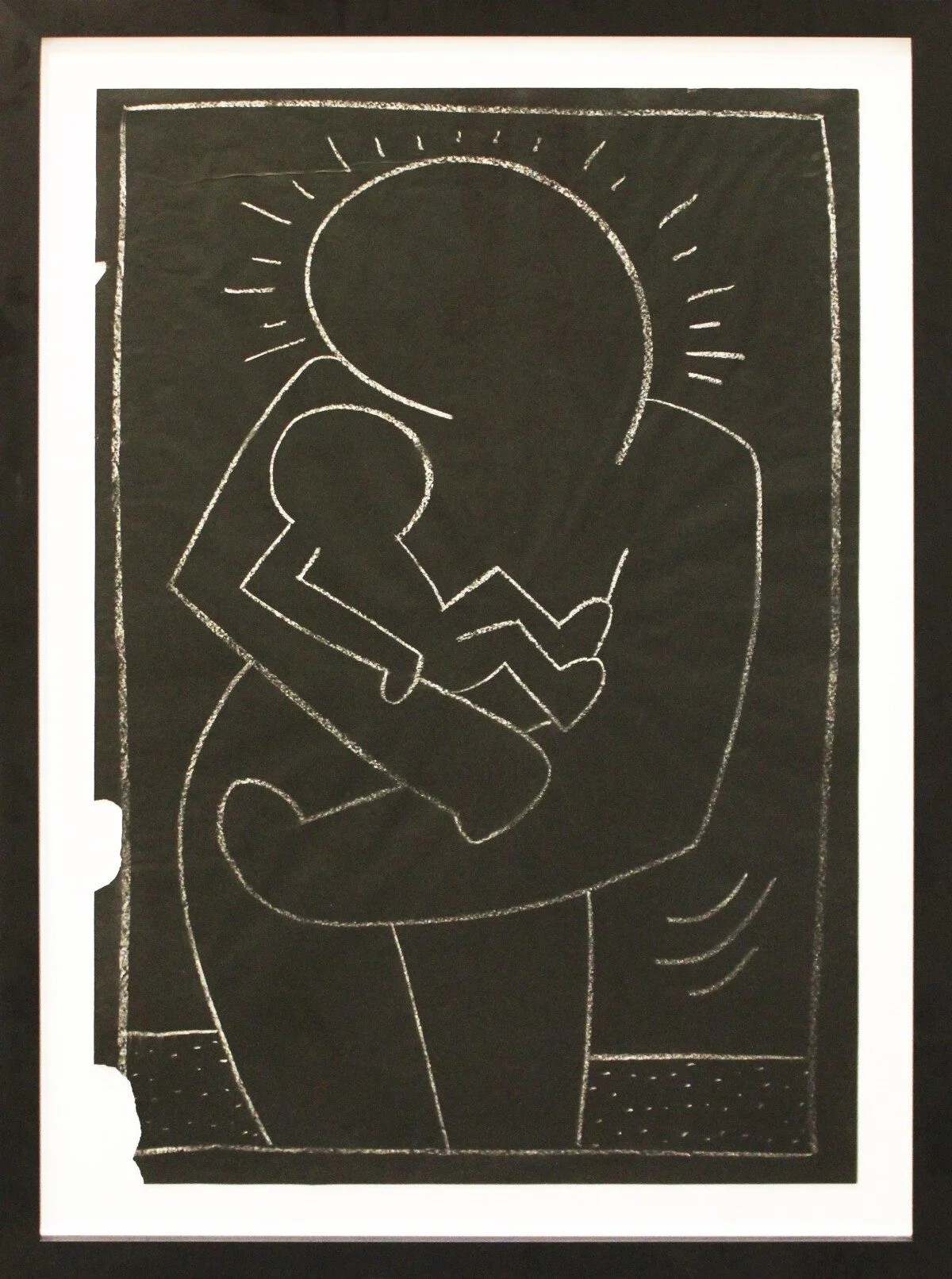 Keith Haring, in 1983, on the black billboard that covered an advertisement in the New York subway, he chalked the sharp contours of this tender Madonna and Child.