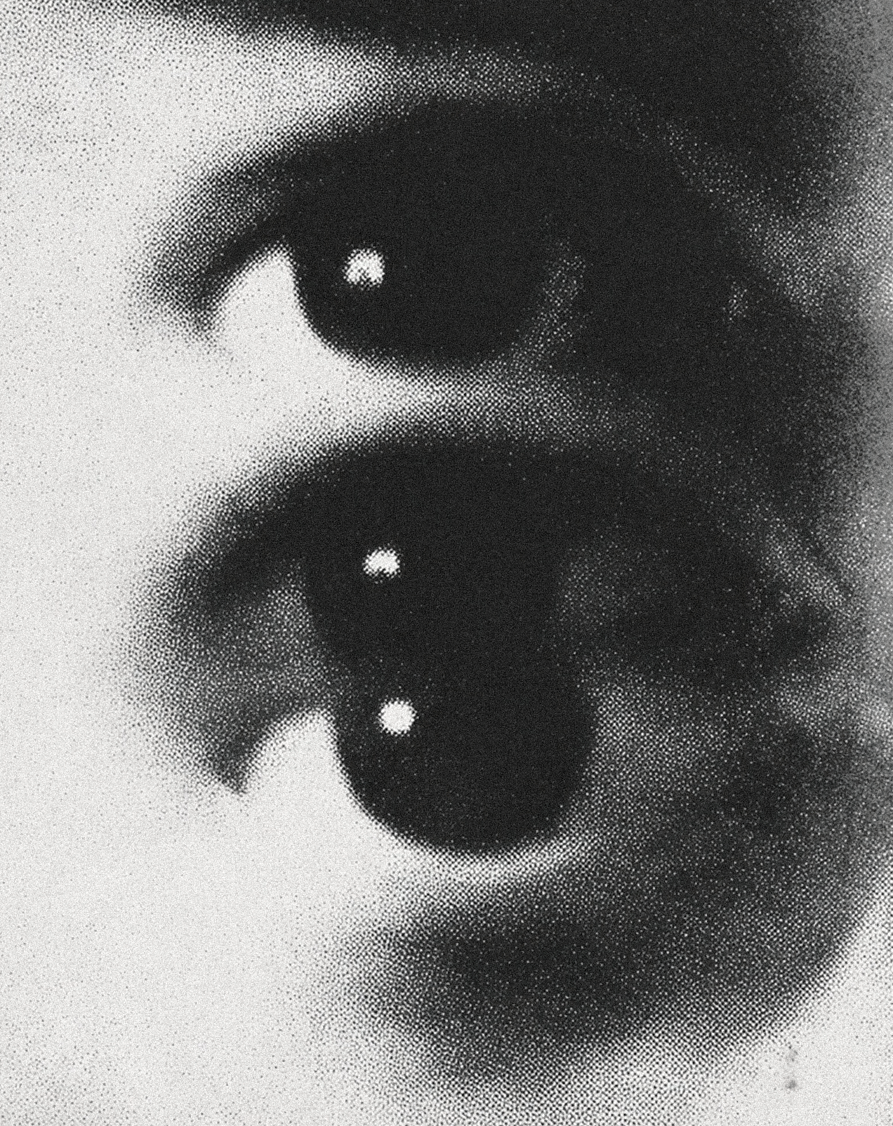 Close-up black-and-white photo of a pair of human eyes.