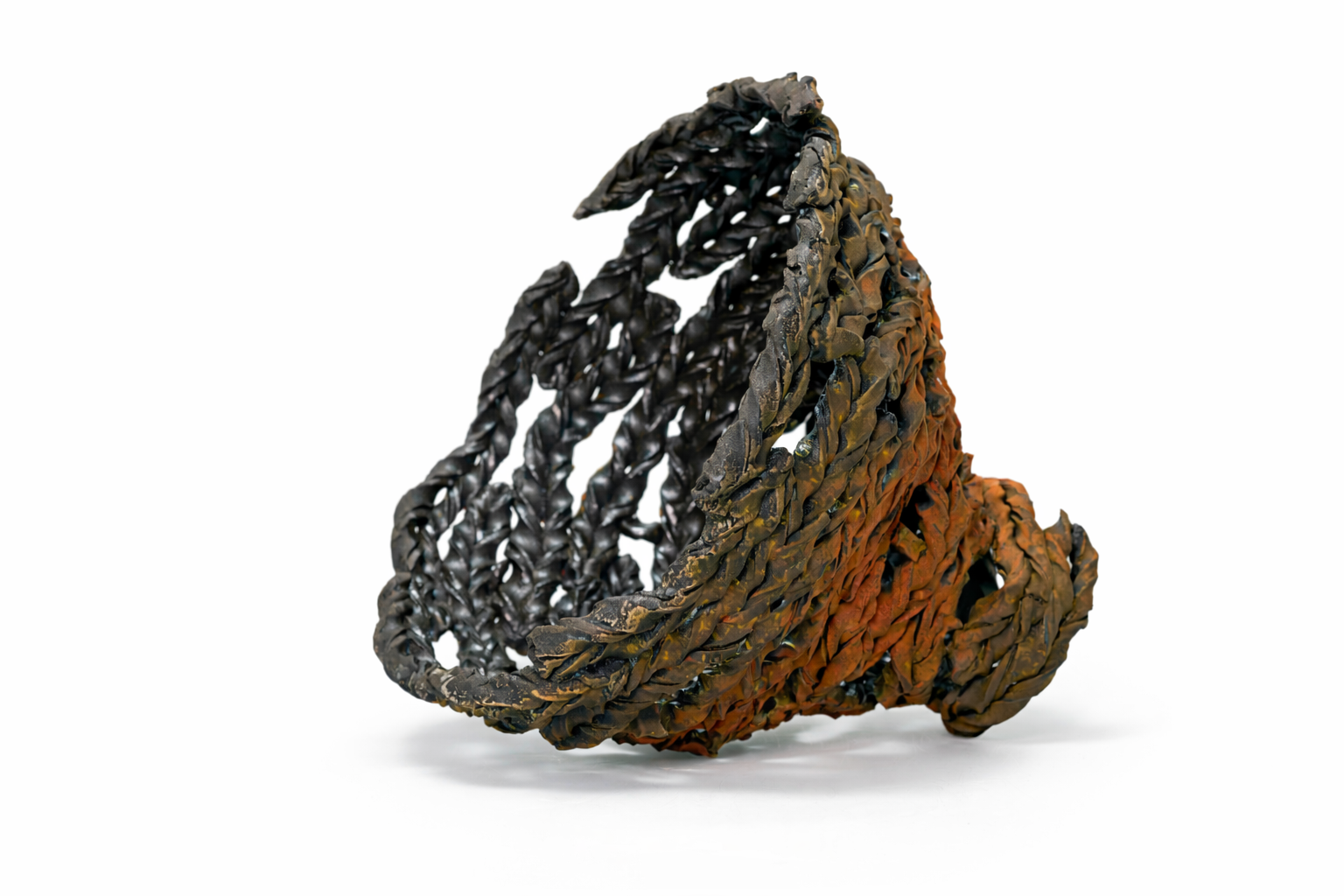 A handmade bracelet woven from black and brown leather strips, displayed against a white background.