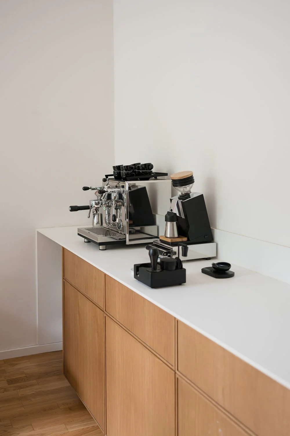Home espresso station with espresso machine, grinder, scale, and brewing tools for crafting café-quality coffee at home.